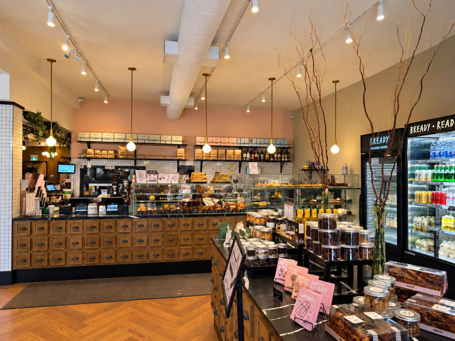 Inside Bready Yonge & Eglinton — pastry counter, bread shelves and café displays