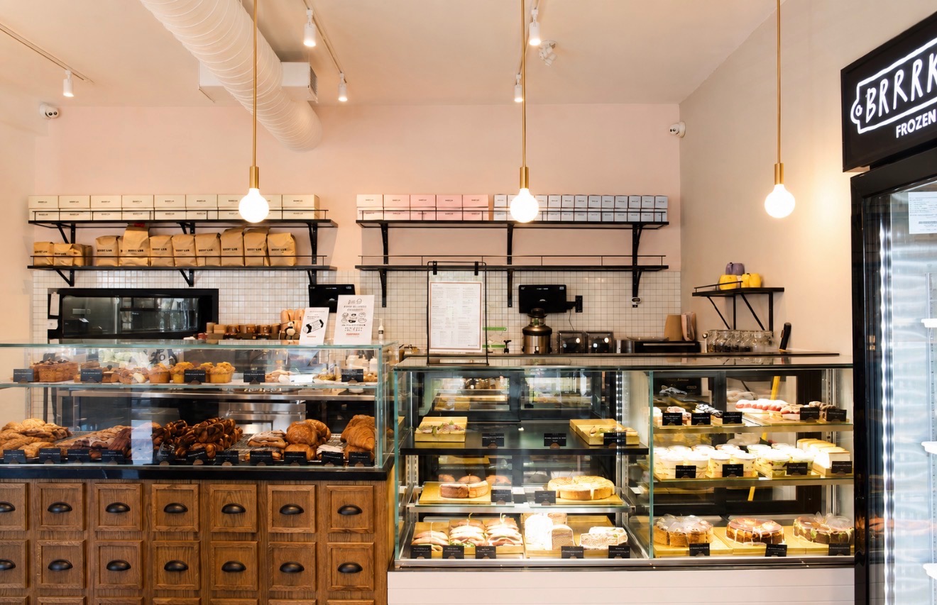 Pastry cases and apothecary drawers at the café counter