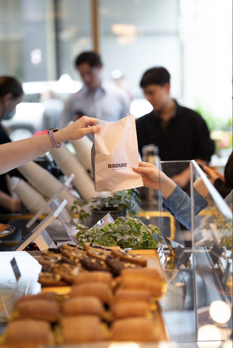 A Bready bag handed over the café counter